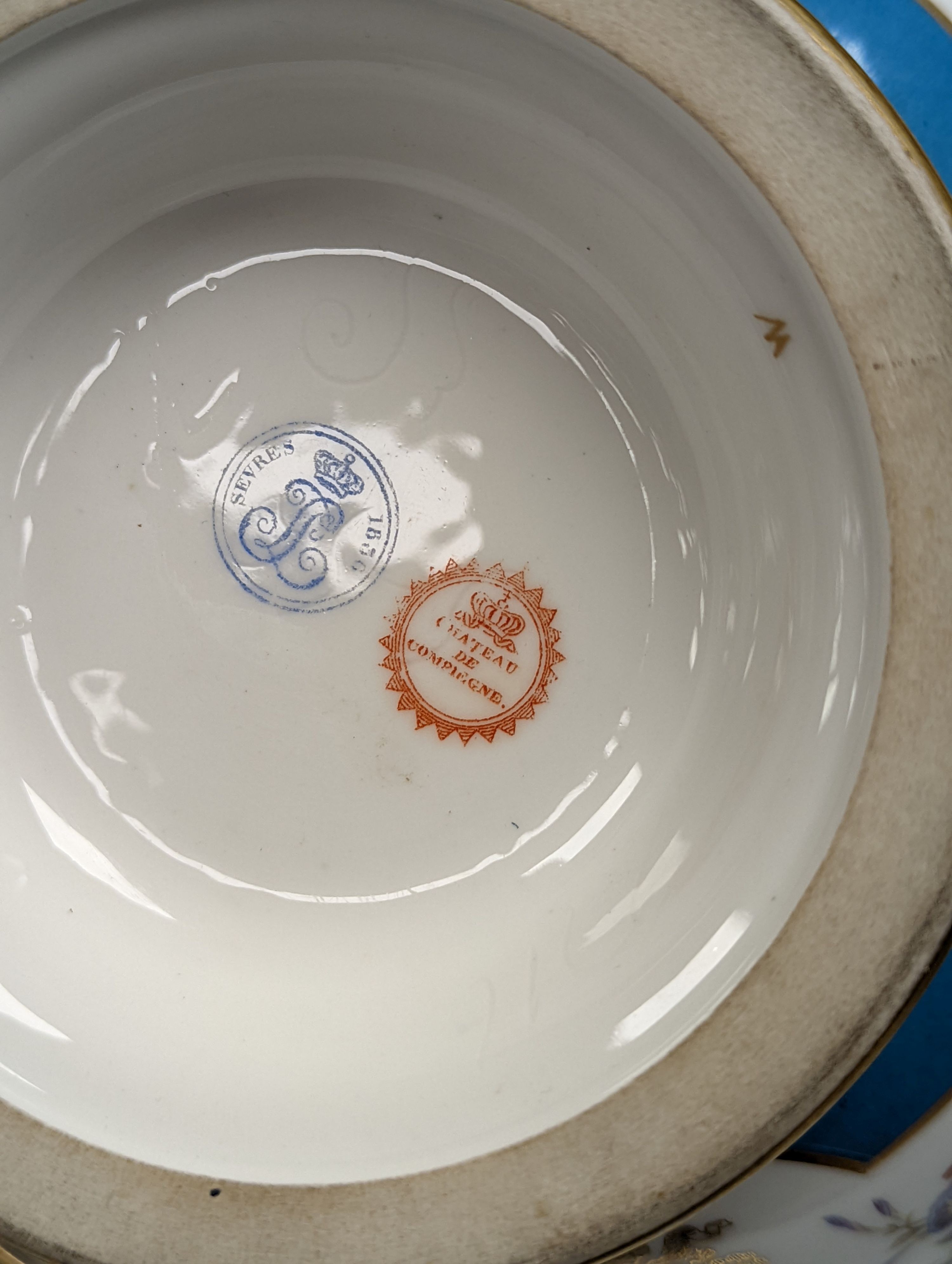 Sevres ecuelle and cover painted with a band of flowers surrounding the gilt monogram of Louis Phillipe, blue mark dated 1850, red mark for Chateau de Compiegne 25cm